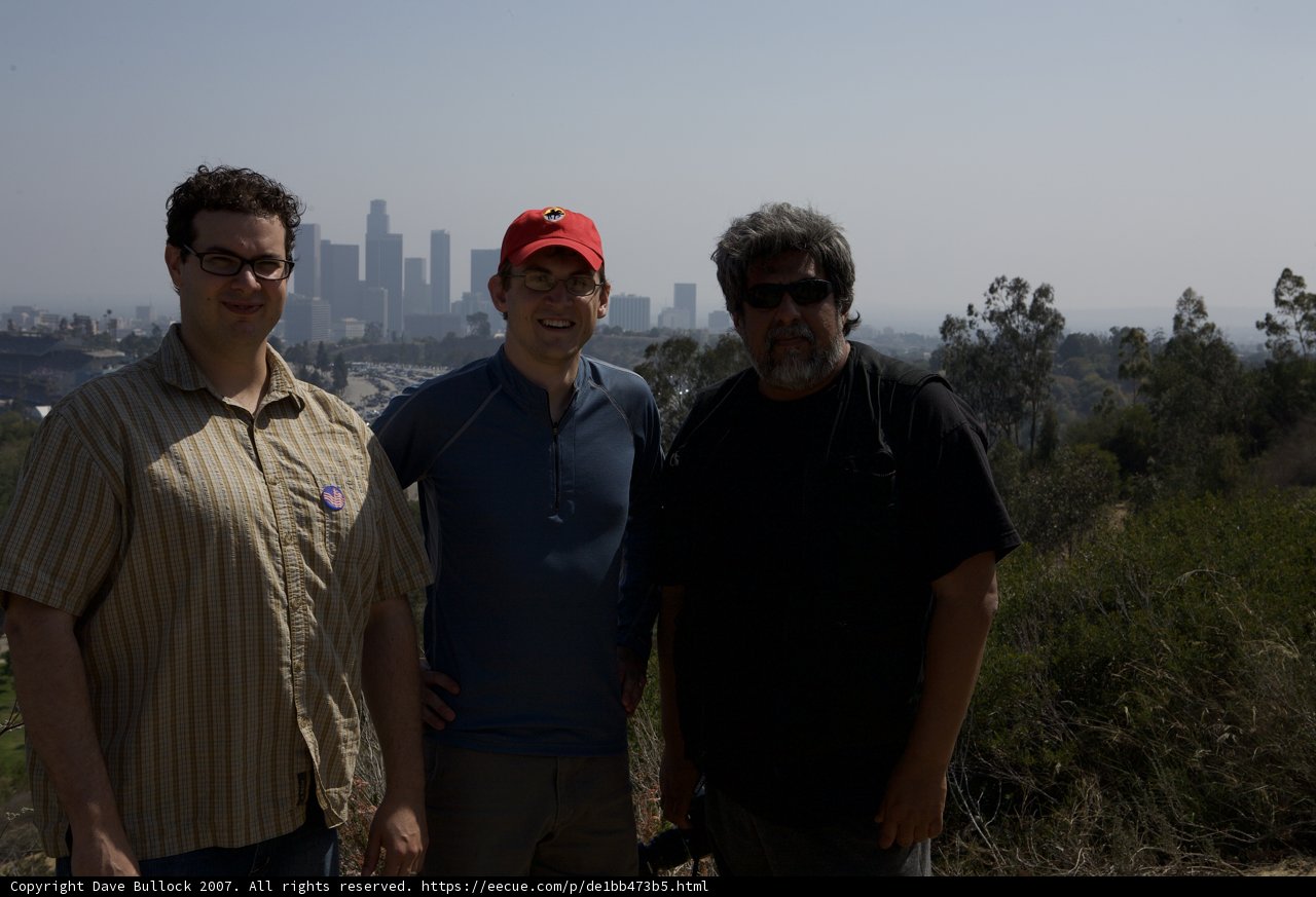 Three Men Enjoying a Picnic in the Park