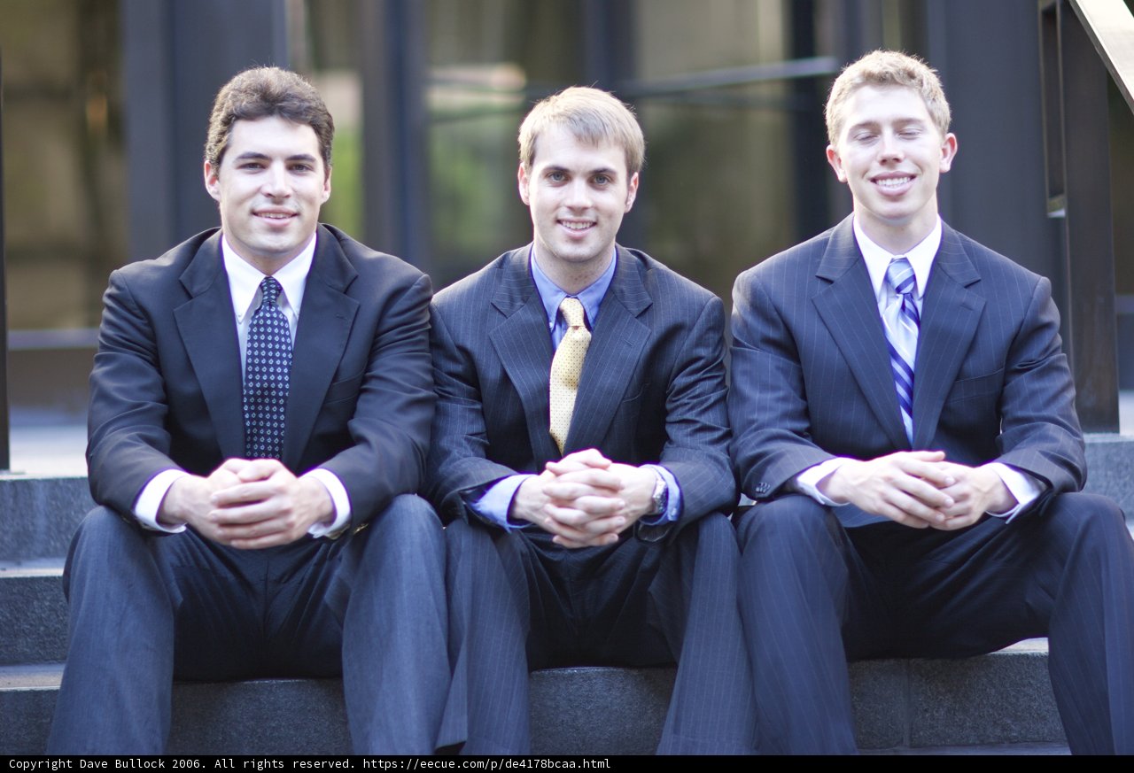Three Men in Suits Take a Break