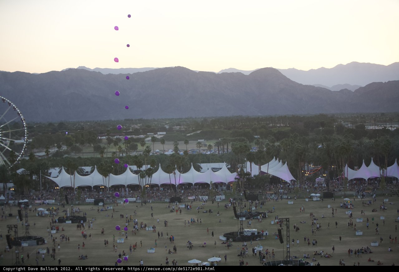 A Festive Crowd with Majestic Mountains