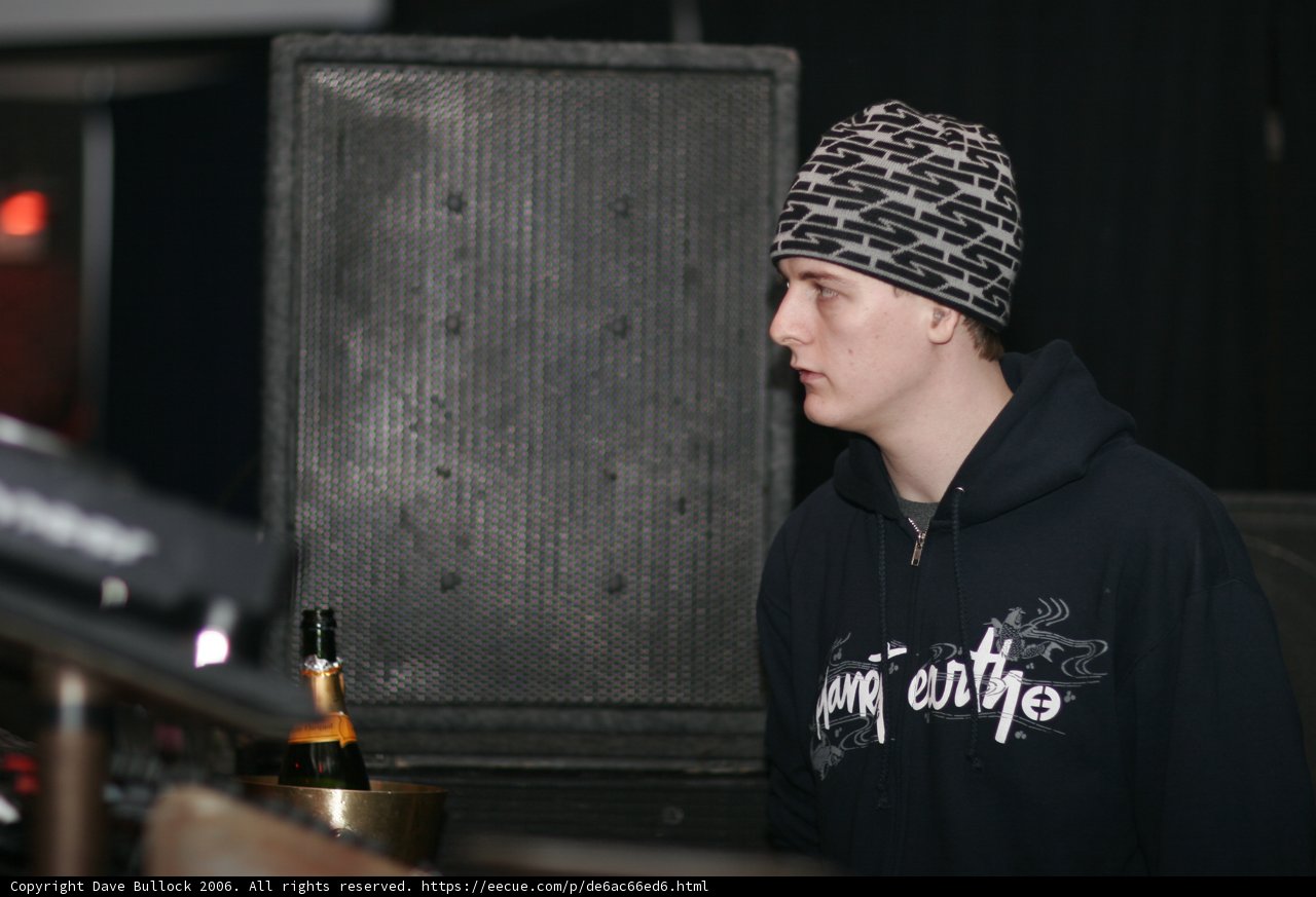 Beanie-clad teen enjoys a beer at the pub