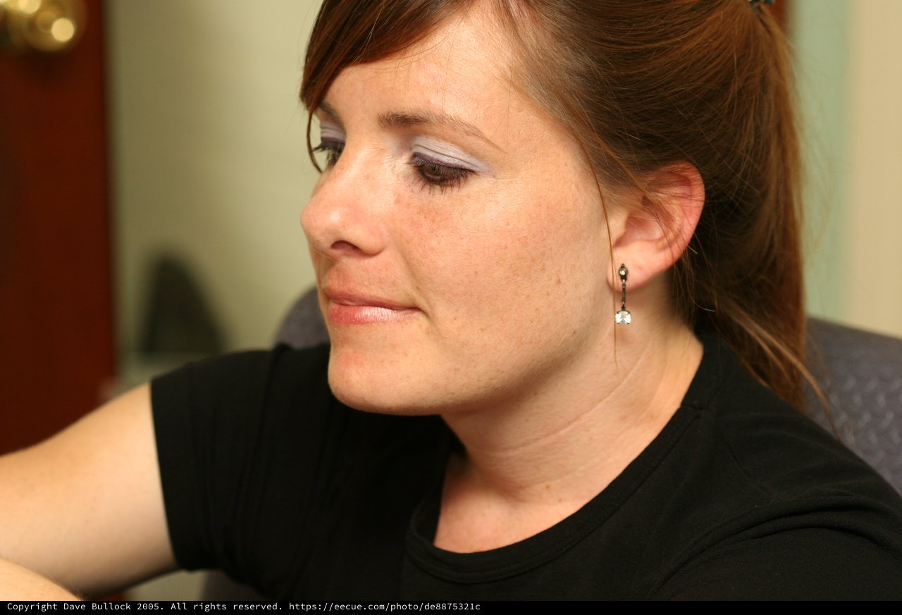 Thoughtful Woman in Profile with Statement Eye Makeup