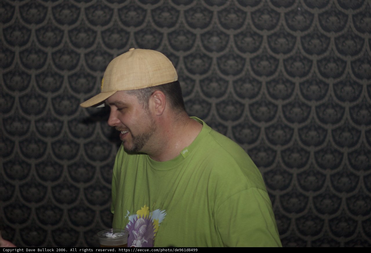 Green Shirted Man with Sun Hat