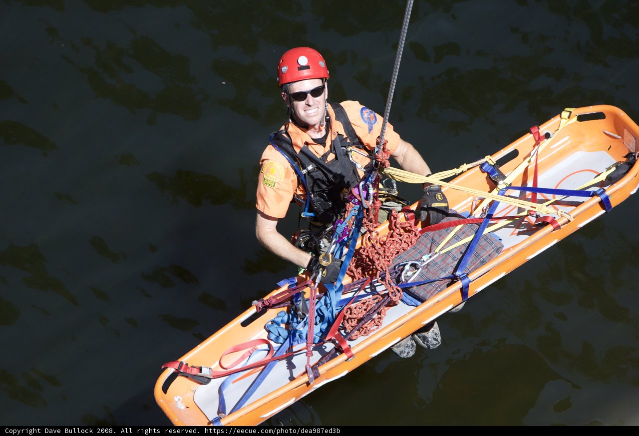 Orange Shirted Man Holds Safety Raft