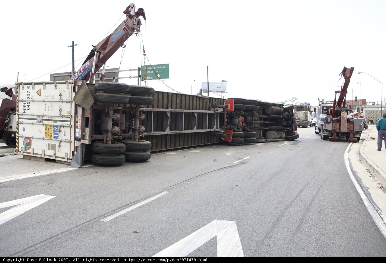 Overturned truck lifted by crane