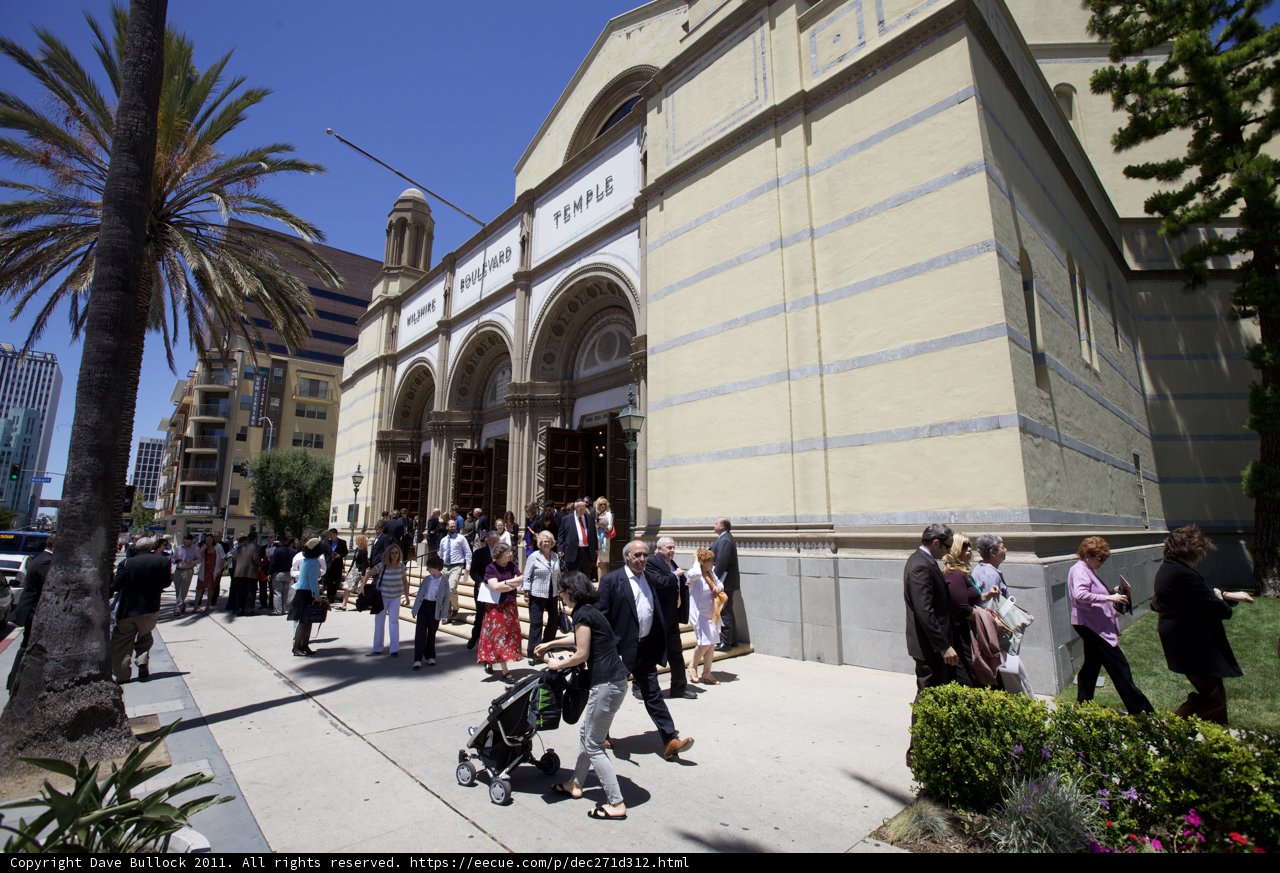 A Crowd of Ordained People Walking in Front of an Architectural Marvel