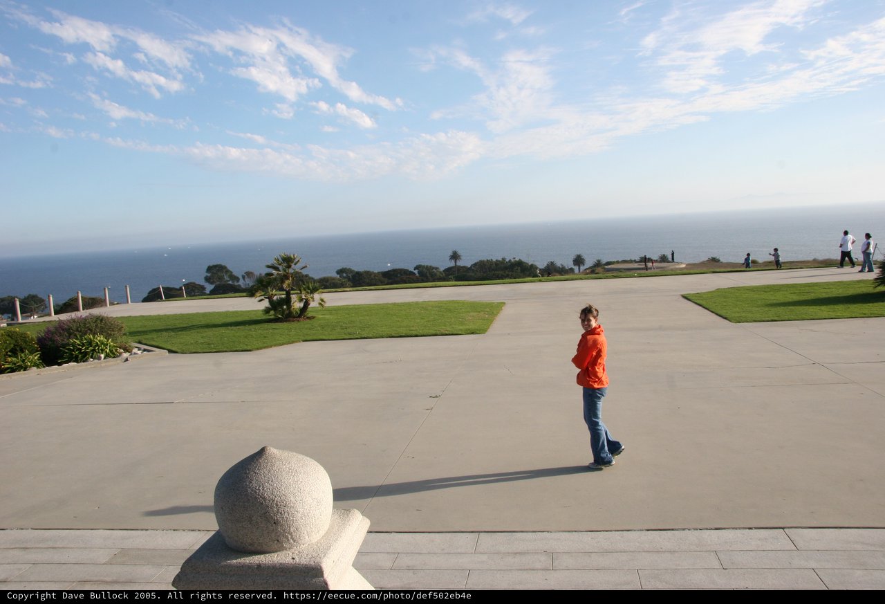 Child in Orange Jacket at Coastal Overlook