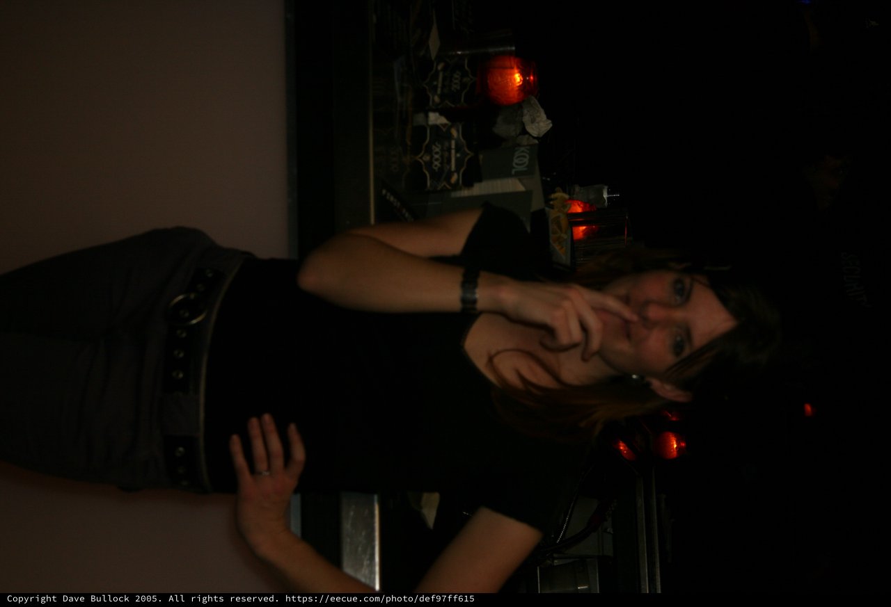 Woman Smoking at a Dimly Lit Bar Counter