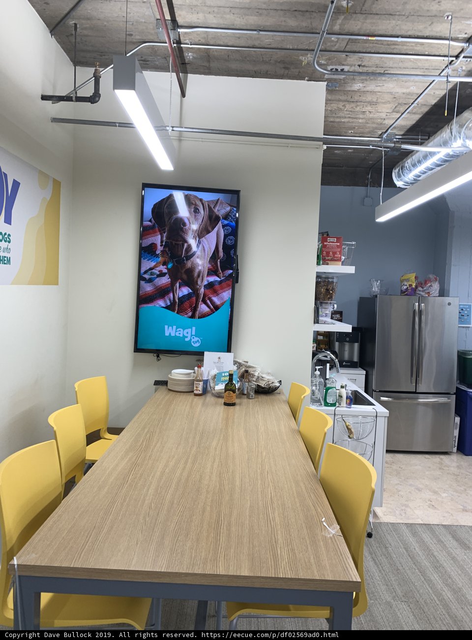 Modern Conference Room with Yellow Chairs and Large Screen