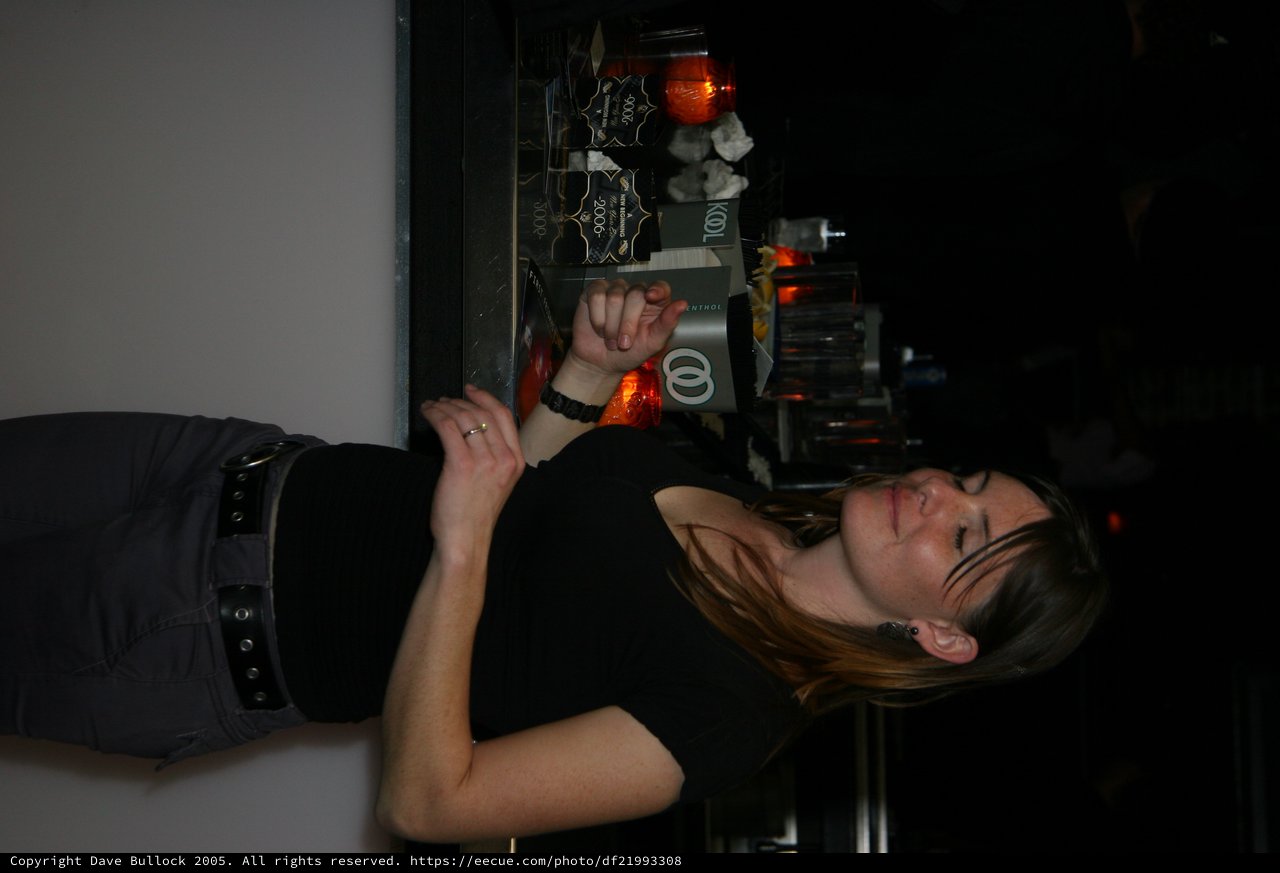 Woman Reading New Year's Eve Program at Nightclub Bar