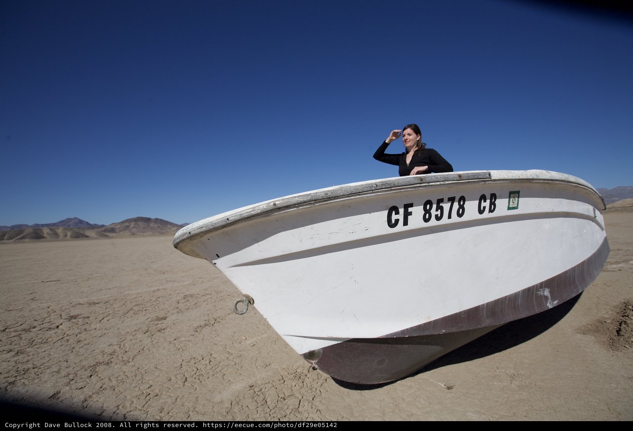 Lost at Sea: Woman Scanning Desert from Abandoned Boat