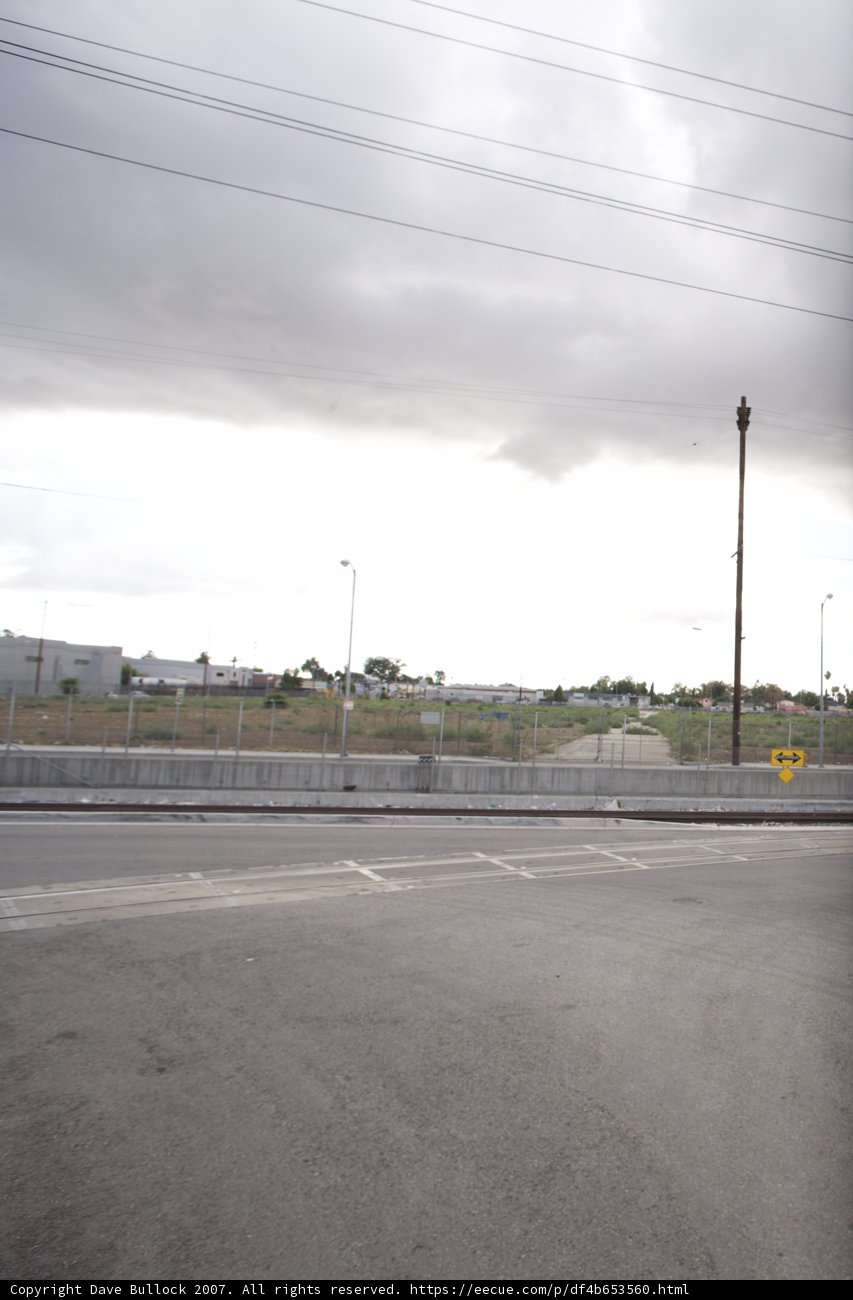 Stop Sign on the Cloudy Tarmac Road
