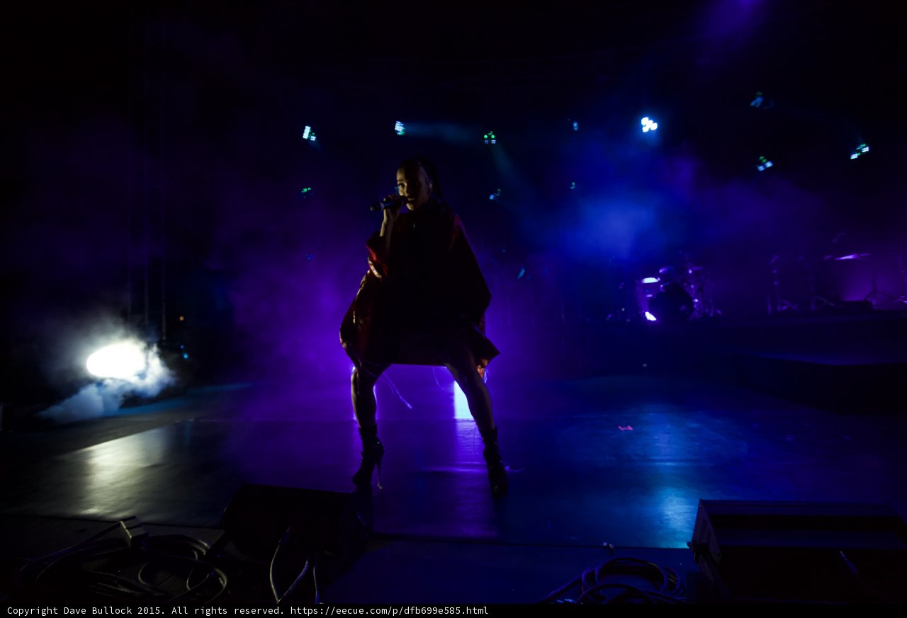 FKA twigs Full Body Wide Silhouette Legs Apart Singing Kimono Draped Shoulders Red Brocade Black Bodysuit Boots Spotlight Drums Heavy Haze