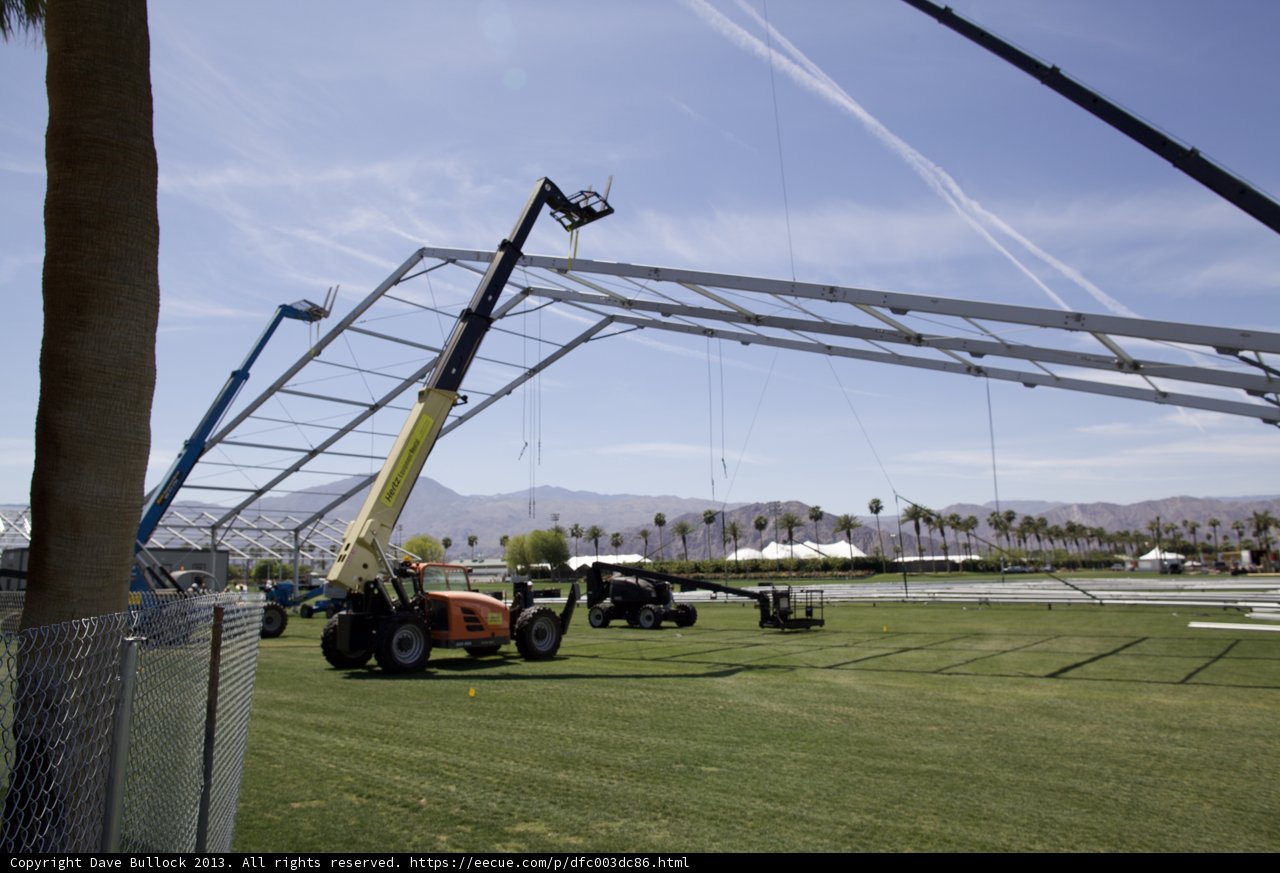 Tractor lifting a large metal structure