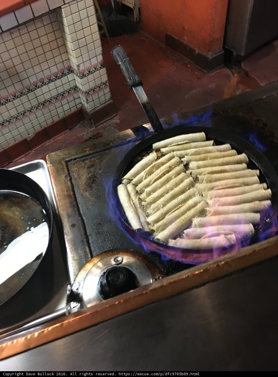 Hot Dogs sizzling on a Cooking Pan