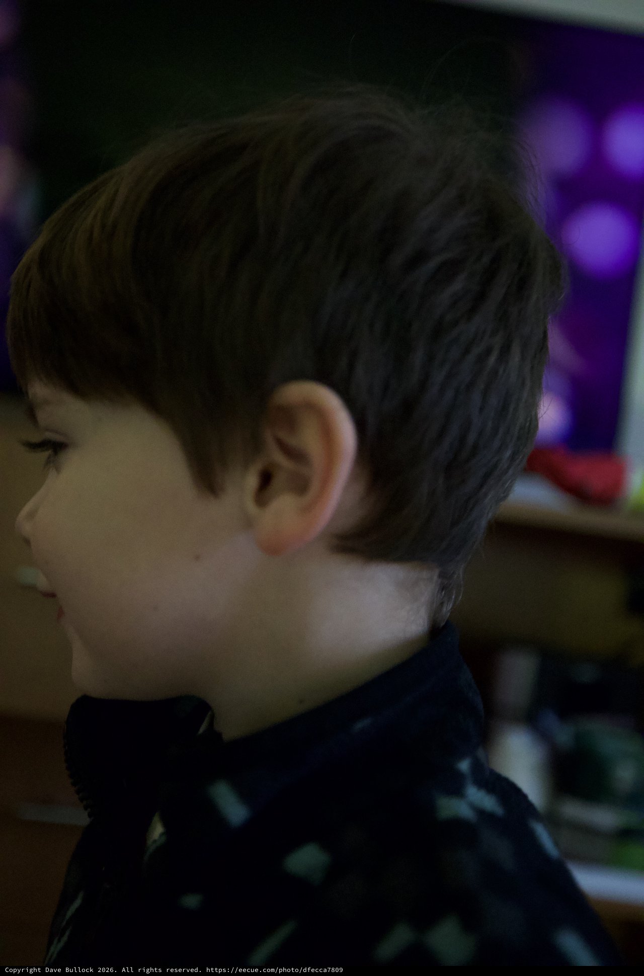 Young Boy in Contemplative Moment at Evening Event