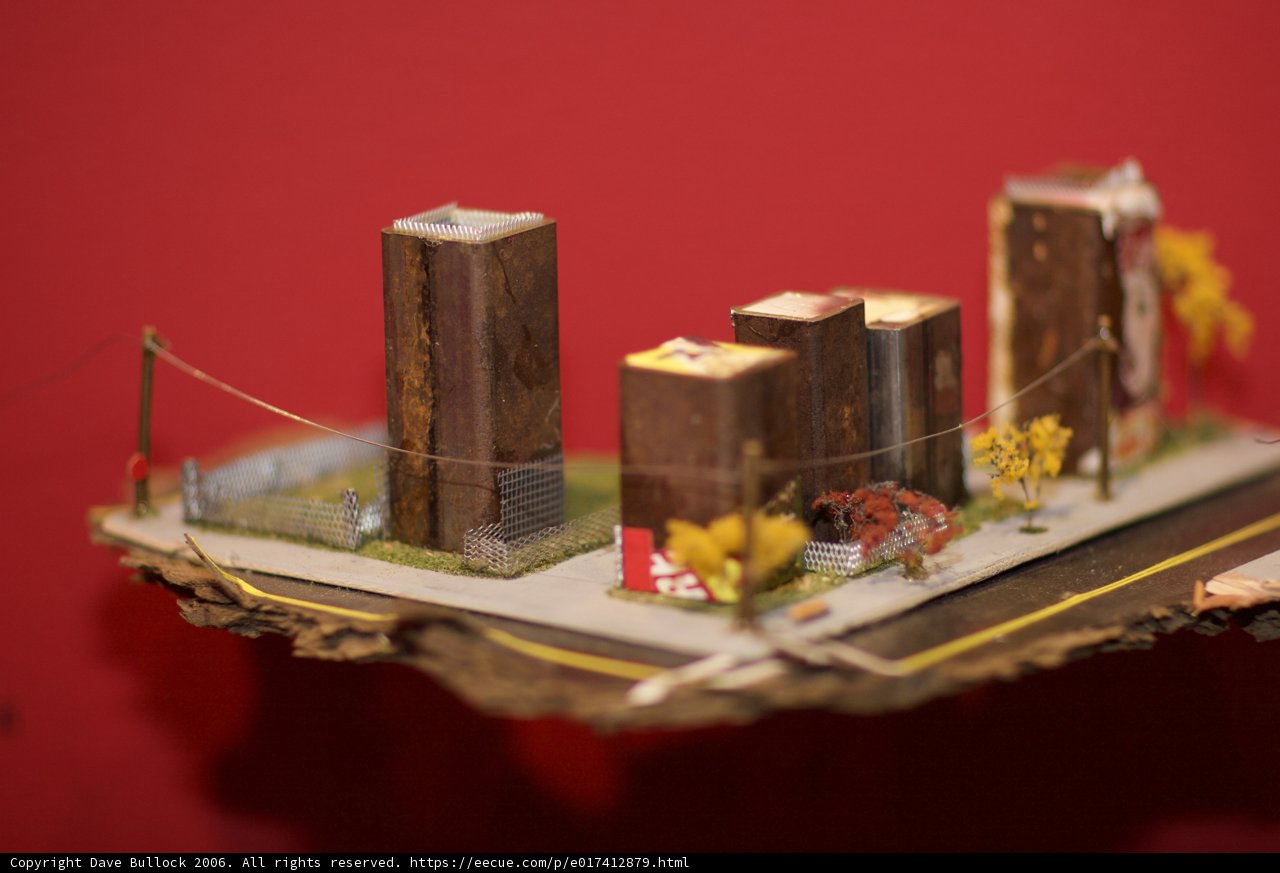 Miniature Cityscape on a Table, Adorned with Sweet Treats and Floral Imageries
