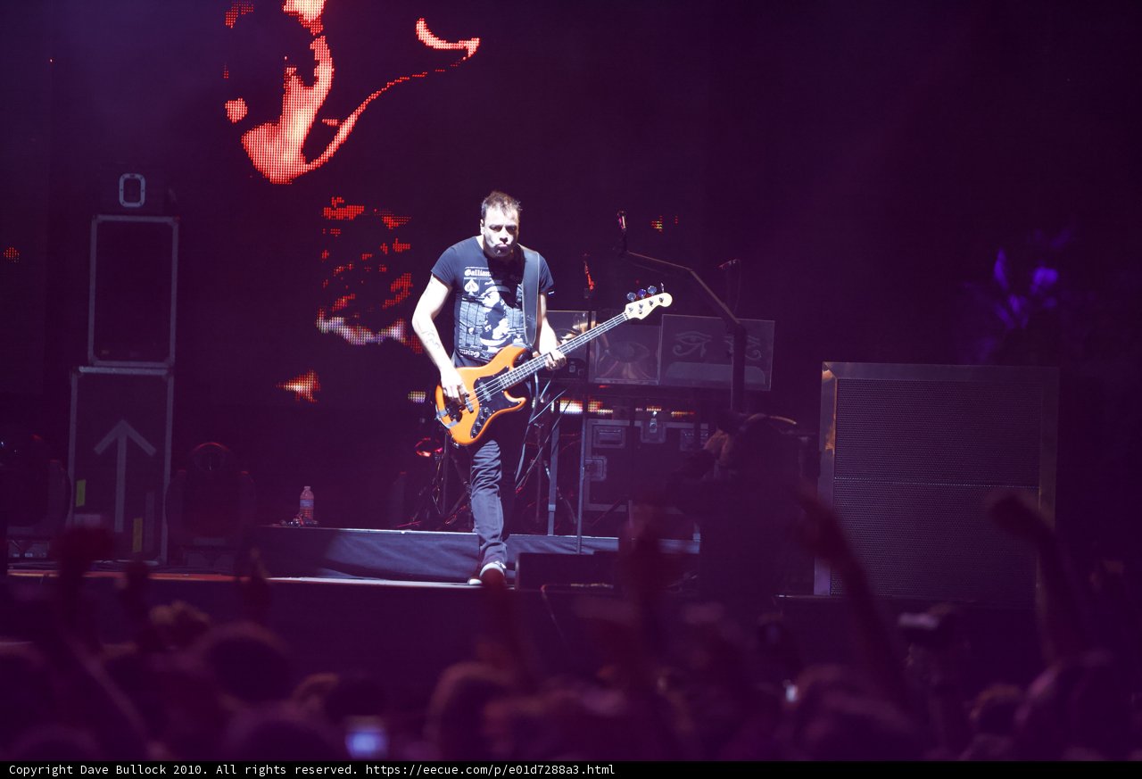 Christopher Wolstenholme Rocking the Stage with his Guitar
