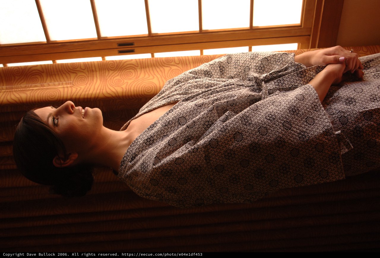 Bride in Robe Gazing Thoughtfully Through Morning Window