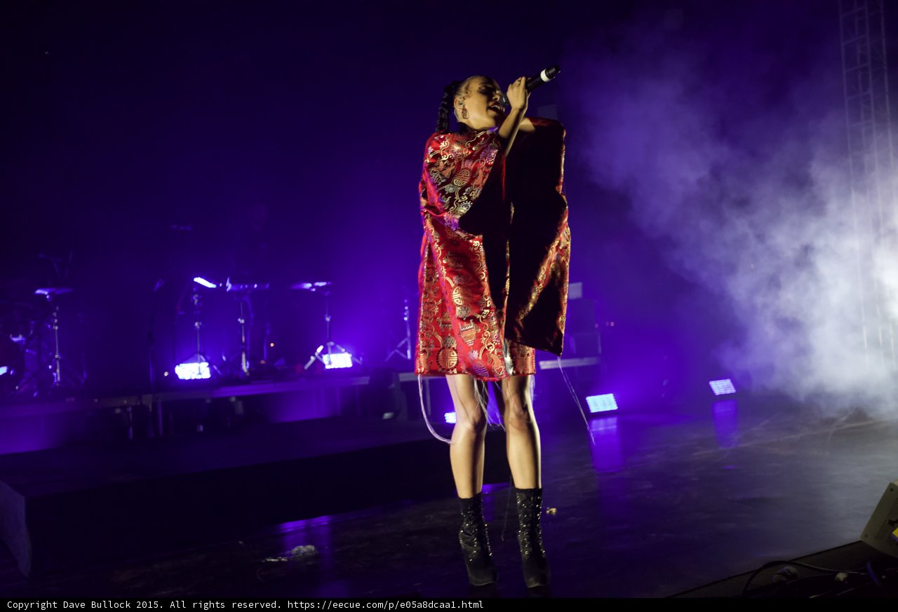 FKA twigs Full Body Singing Microphone Raised Looking Up Kimono Red Brocade Gold Patterns Black Bodysuit Boots Purple Lighting White Haze LED Panels Band Stage Monitor