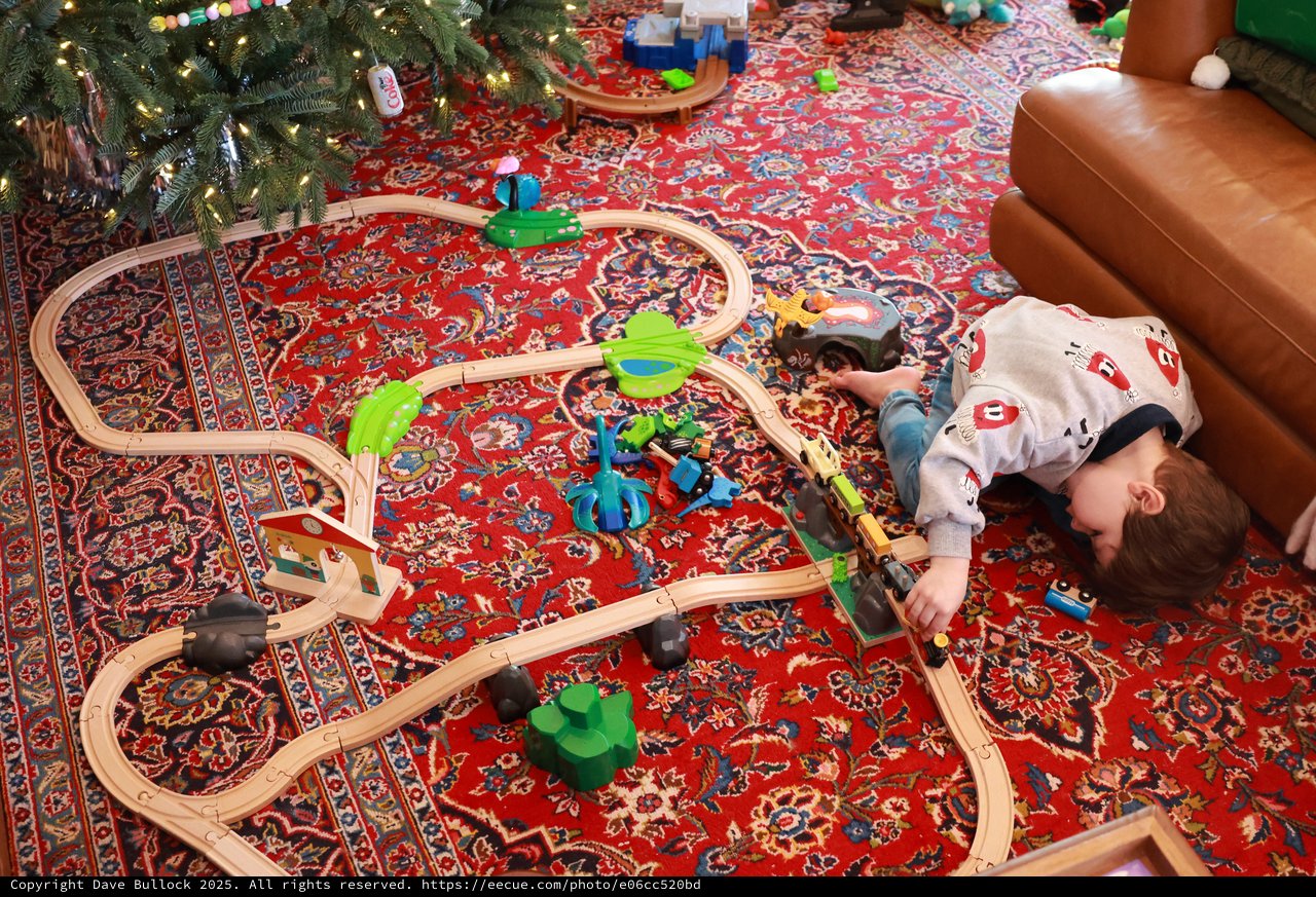 Child Playing with Wooden Train Set on Christmas Day