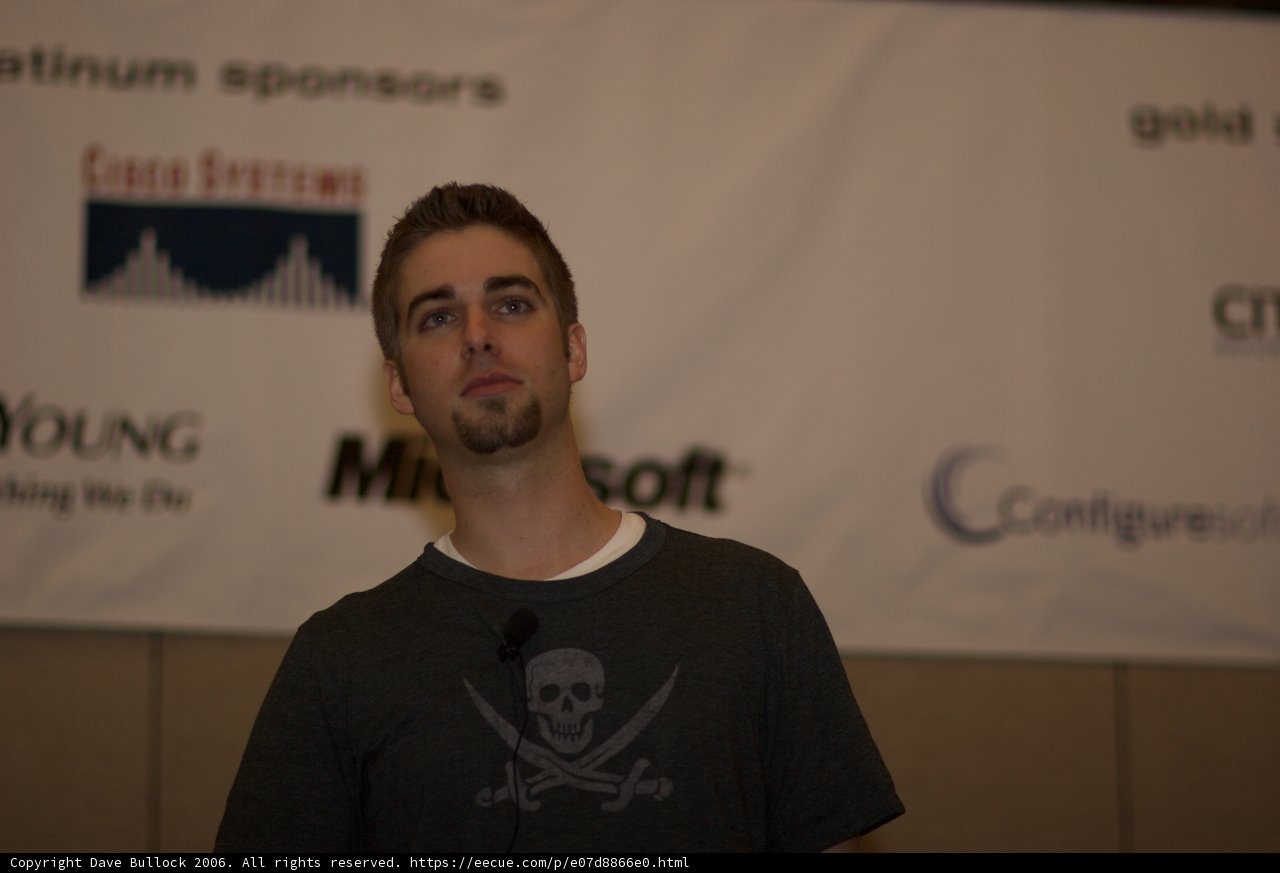 Grey Shirt in Front of the Banner