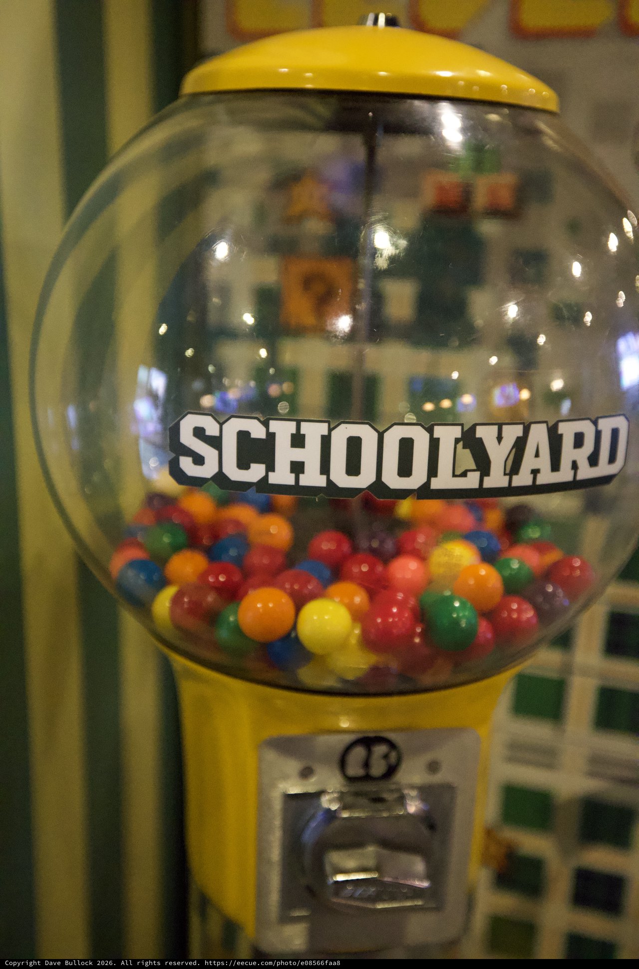 Vintage Yellow Schoolyard Gumball Machine with Colorful Candy