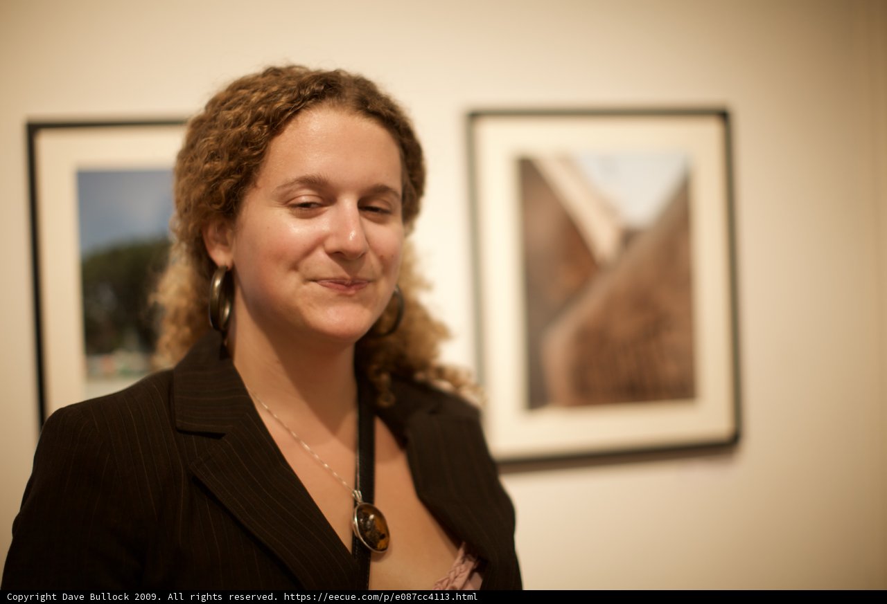 Curly-Haired Woman Poses with Art Frame
