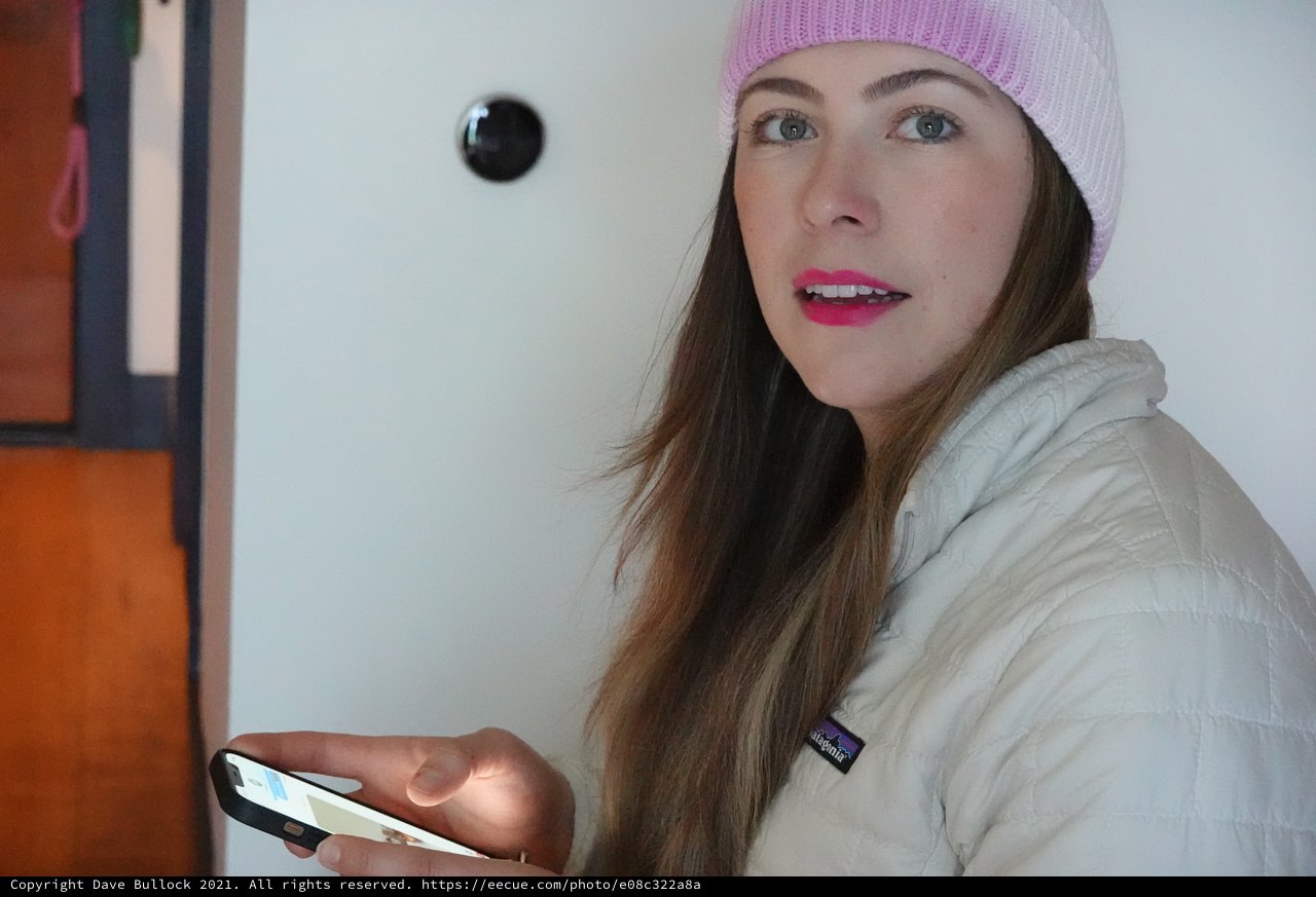 Woman with Pink Beanie Using Smartphone Indoors
