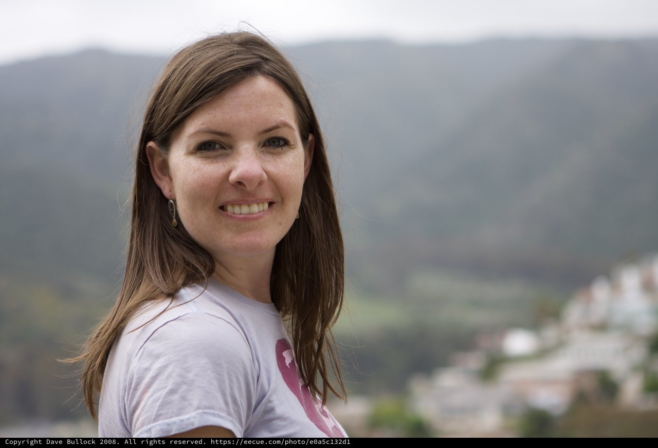 Smiling Woman Overlooking a Mediterranean Hillside Town