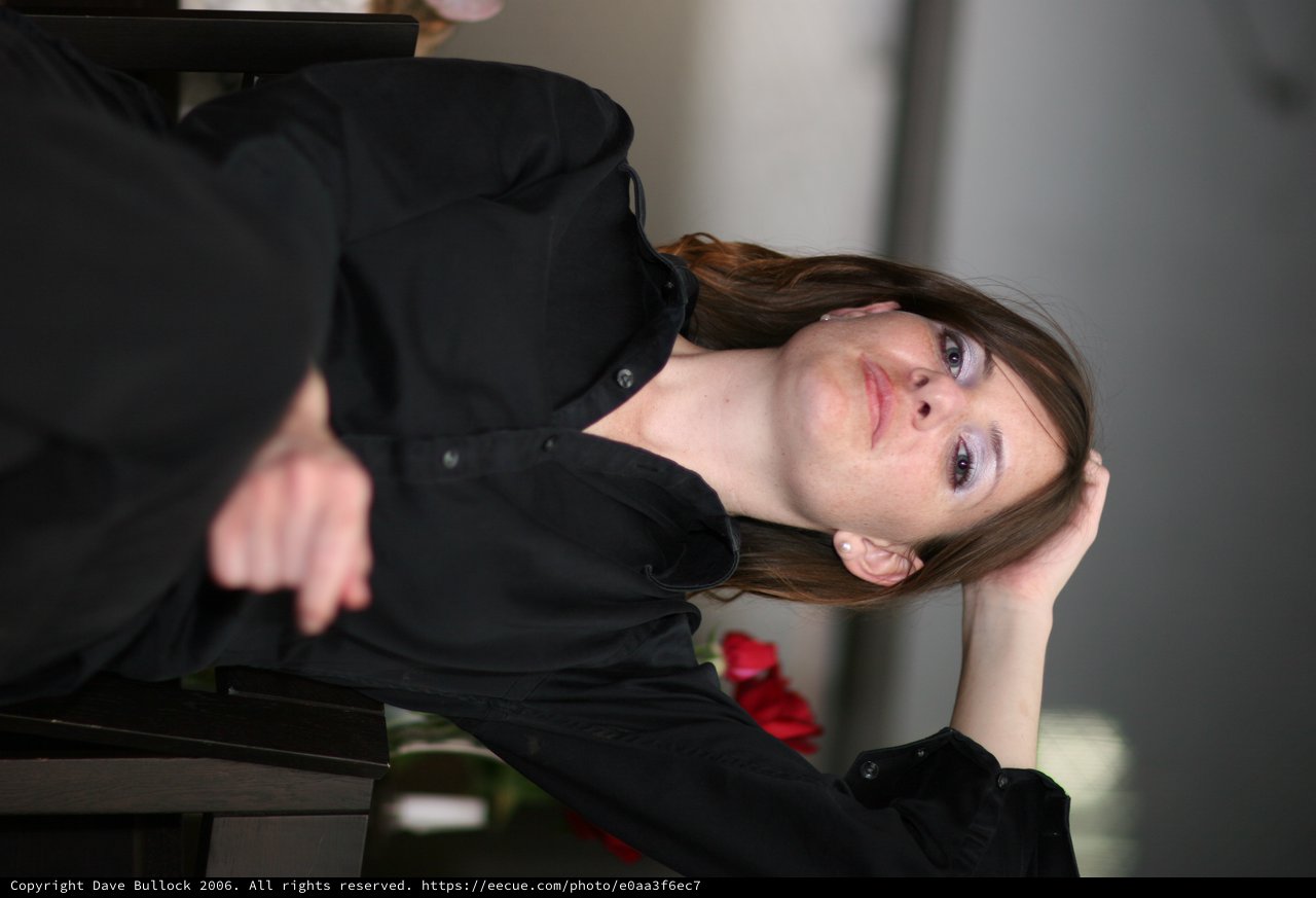 Contemplative Woman in Black at Office Setting