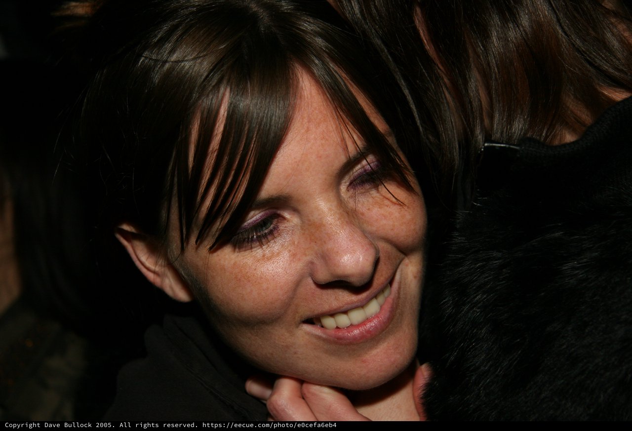 Joyful Woman Smiling During Warm Embrace