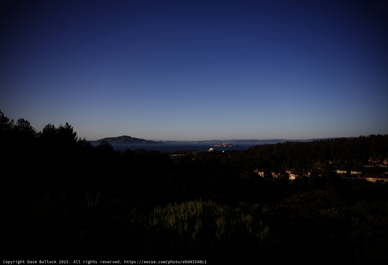A Serene Ocean and Mountain Vista from the Hill