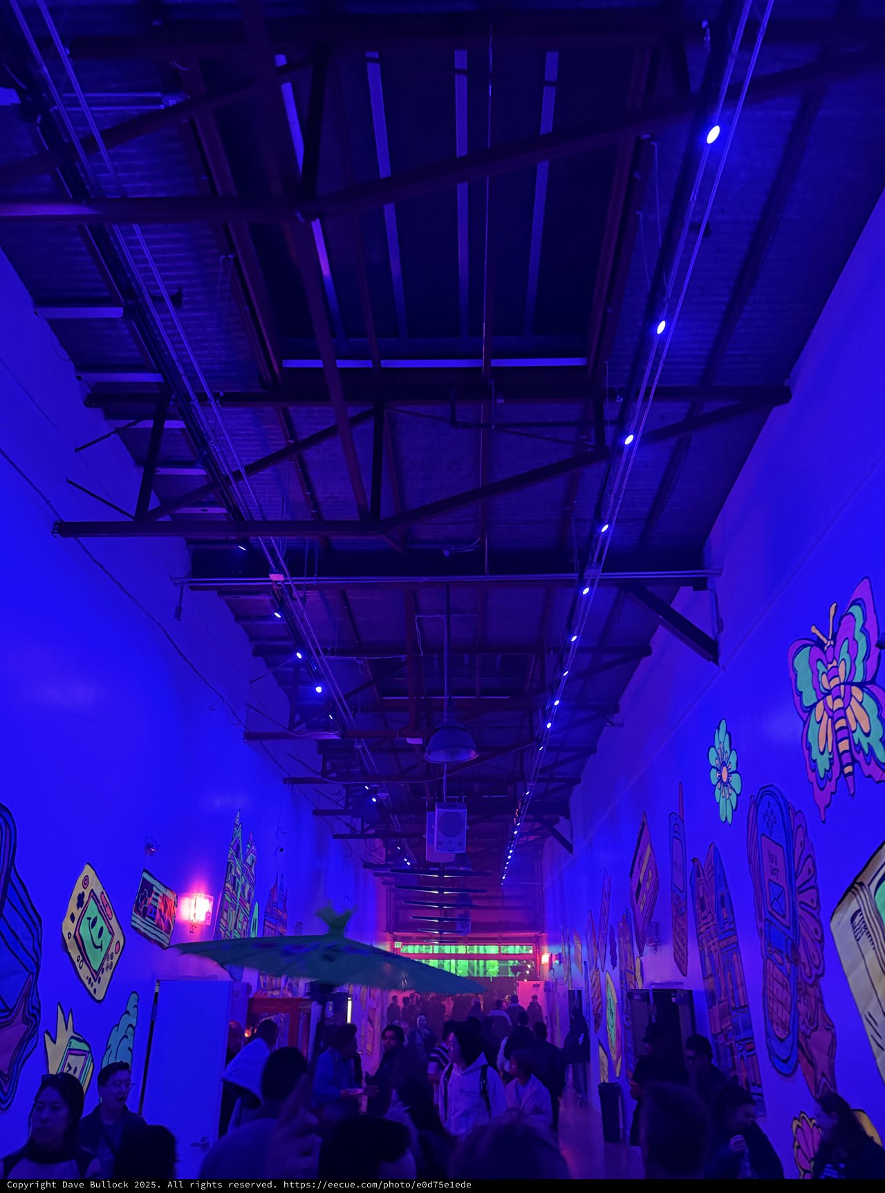 Immersive Blue-Lit Electronic Music Venue with Crowd