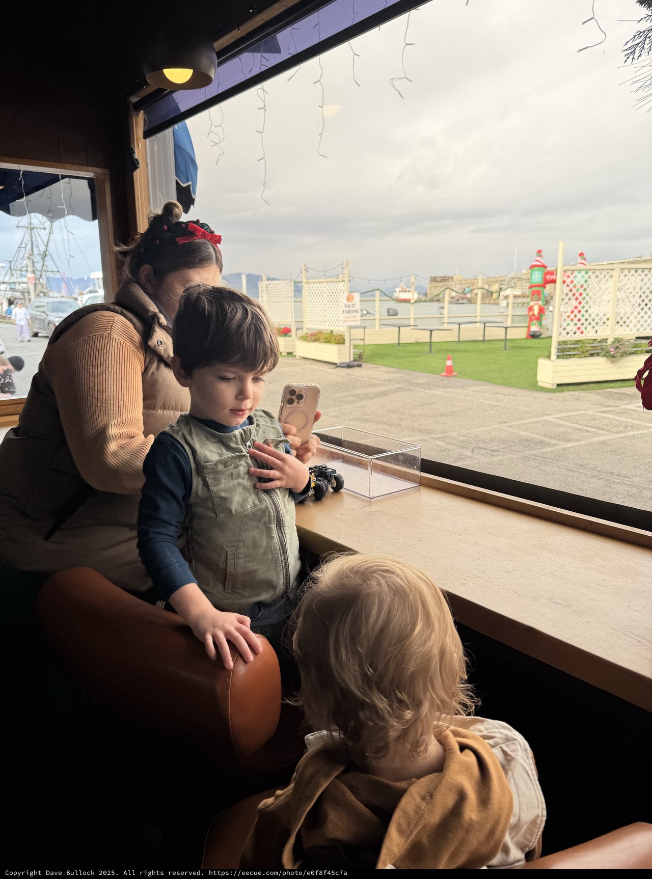 Family Moment by the Window at Winter Attraction