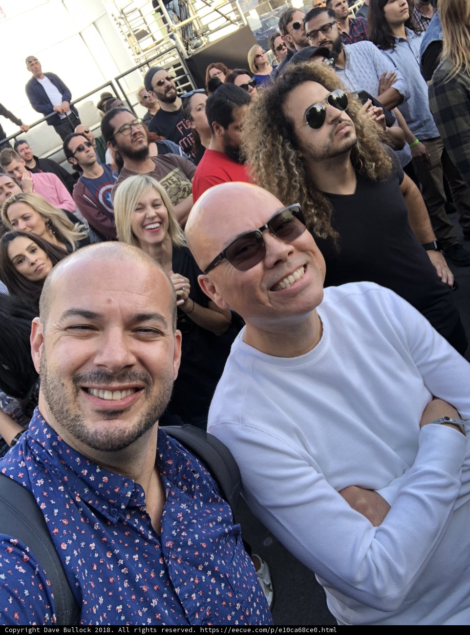 Smiling Duo in Front of a Thrilled Crowd