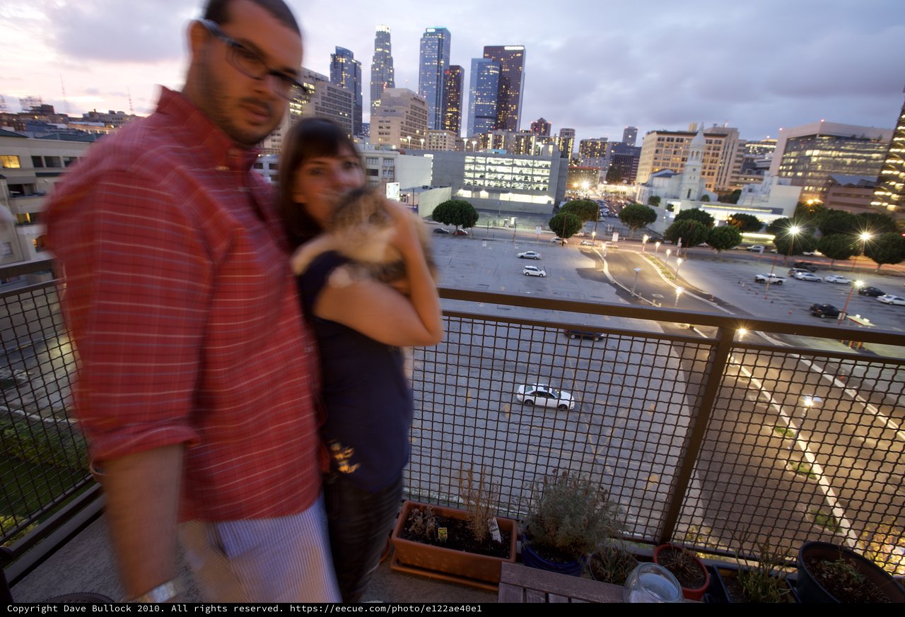 Couple Embracing on Urban Balcony at Dusk