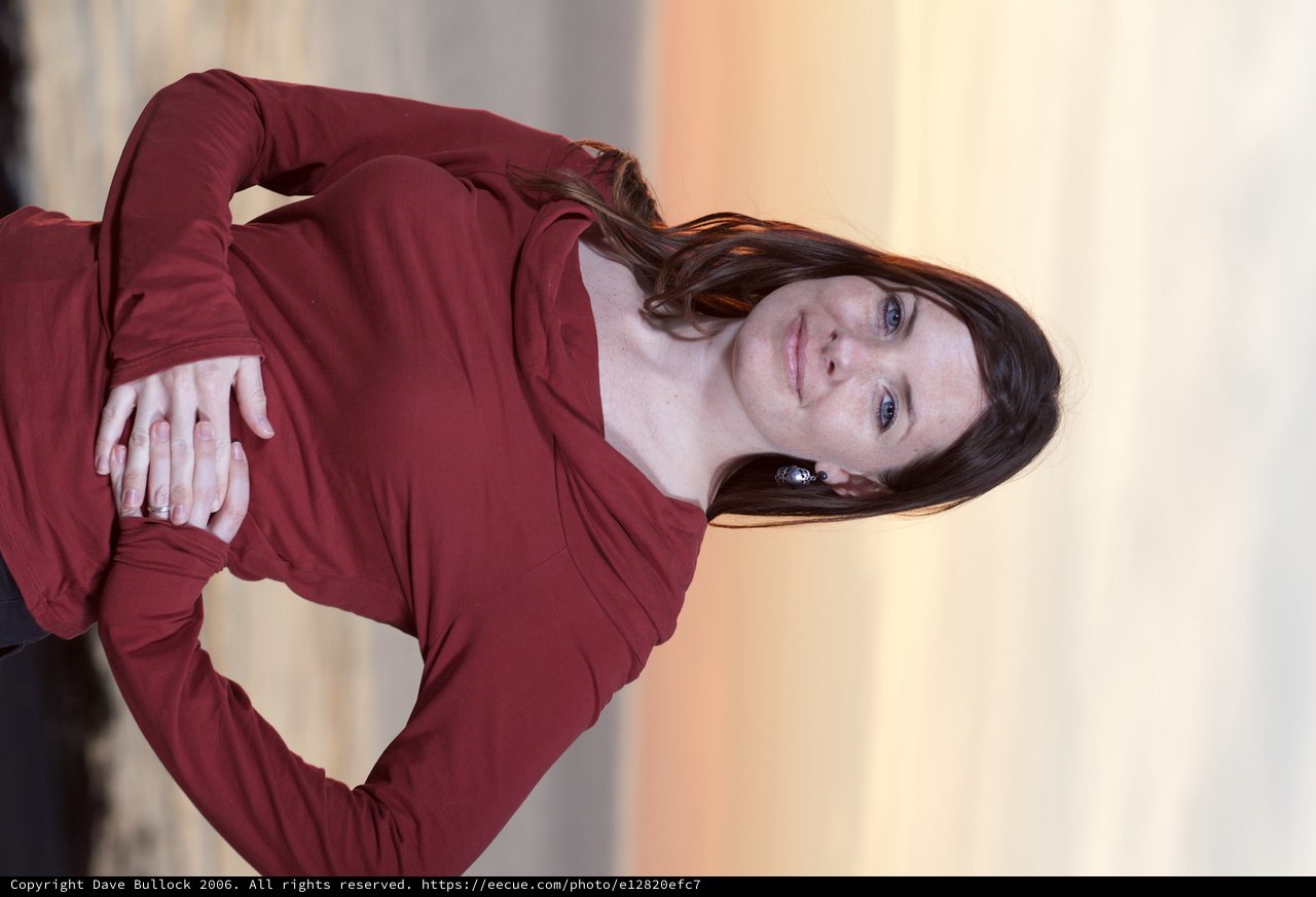Confident Woman at Coastal Sunset in Crimson