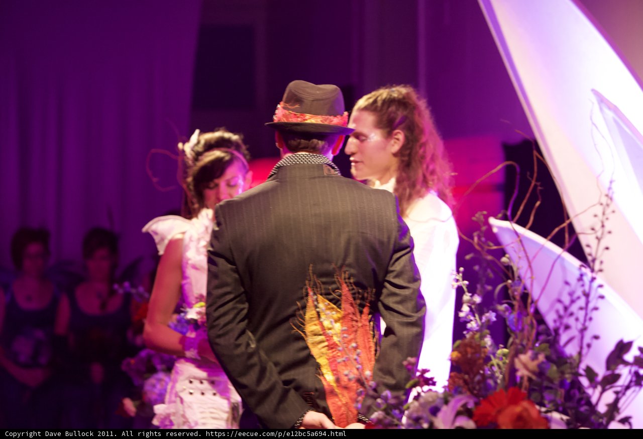 The Bride and Groom with a Stunning Flower Arrangement