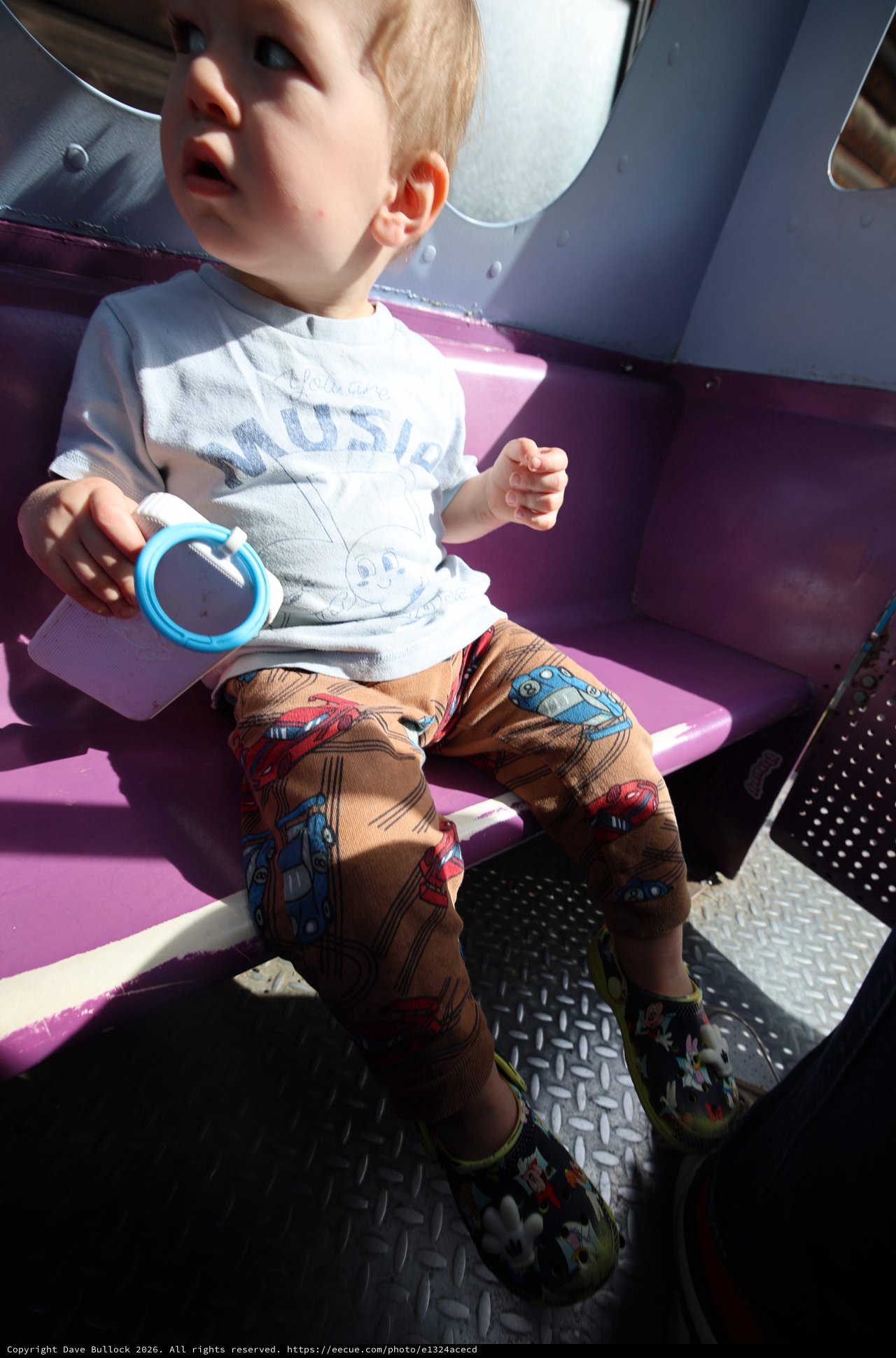 Toddler Enjoying a Sunny Ride at Fantasyland