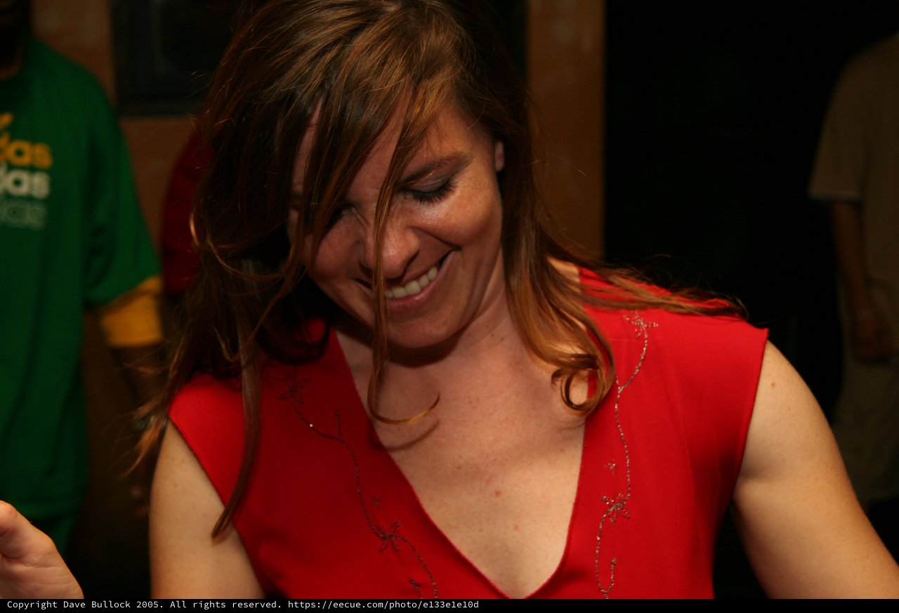 Joyful Woman in Red Laughing at Party