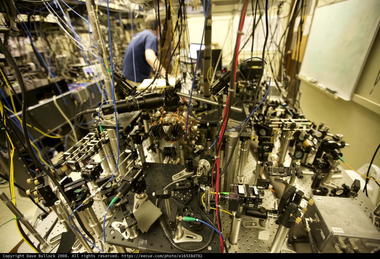 Innovating the Quantum World Caption: A man carefully works on a machine in a high-tech lab, focused on making breakthroughs in manufacturing and electronics.