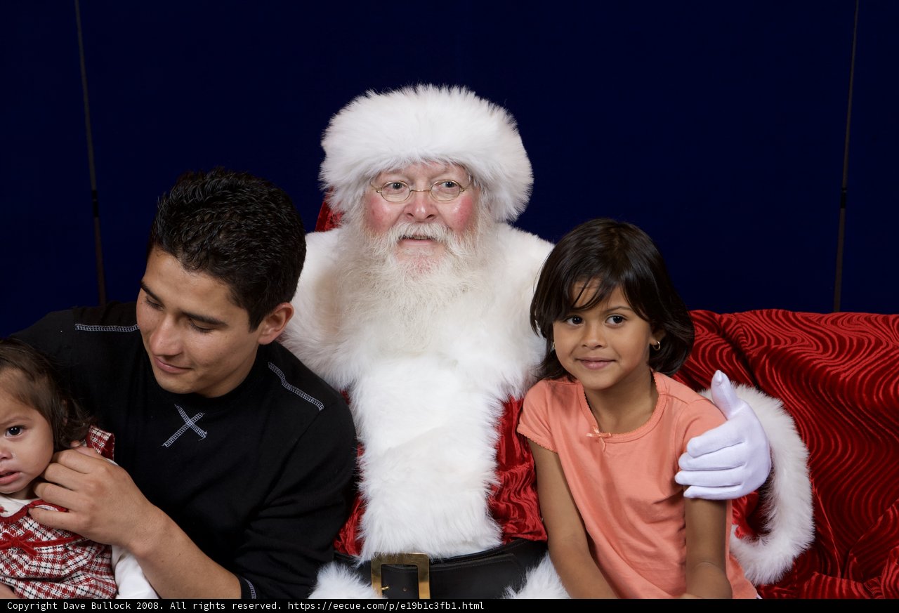 Santa Claus brings smiles to a family on the couch