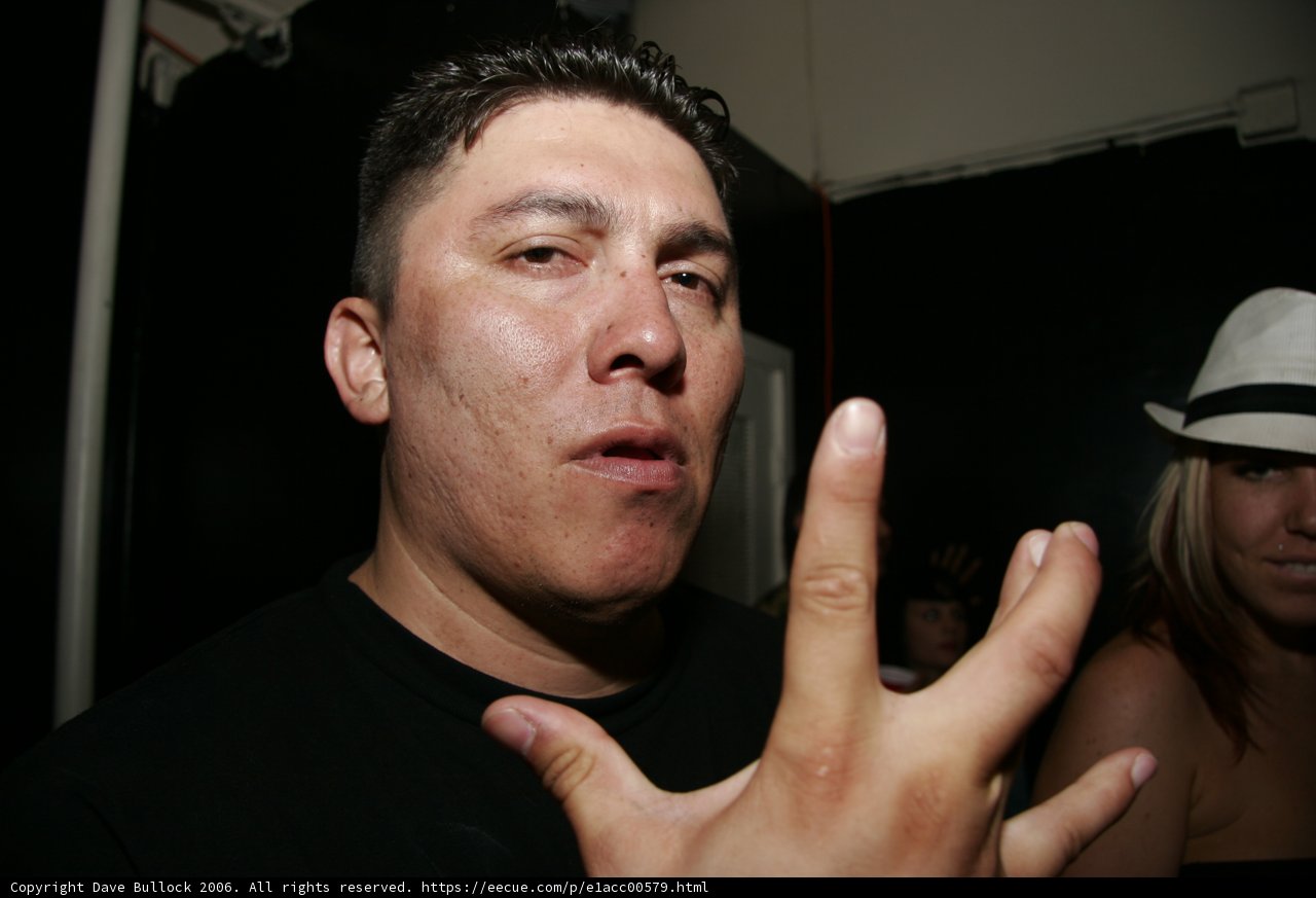 Black Shirted Man Sporting a Baseball Hat
