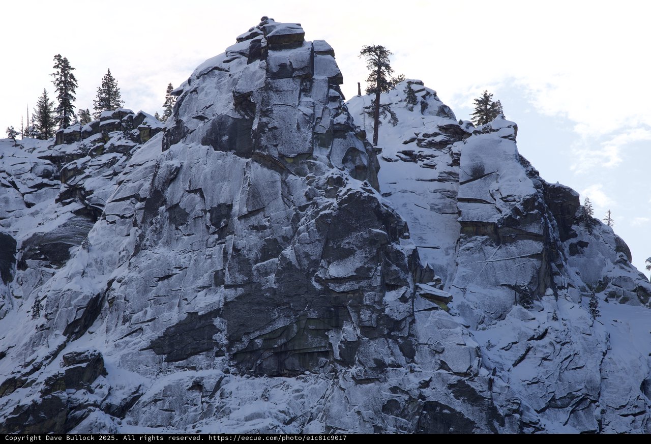 Snow-Covered Rocky Peak in Winter Mountain Landscape
