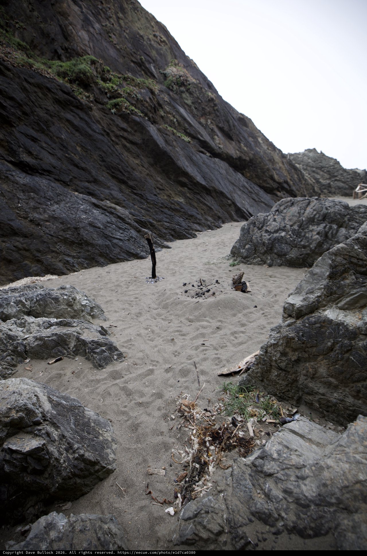 Secluded Rocky Cove With Remnants of Beach Campfire