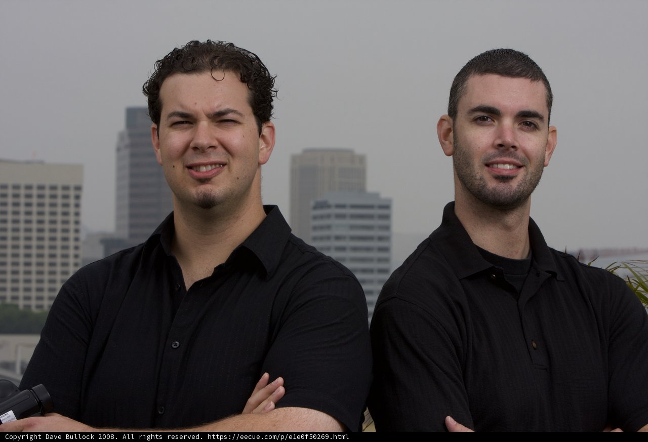 Two Happy Men Against a Towering Skyscraper