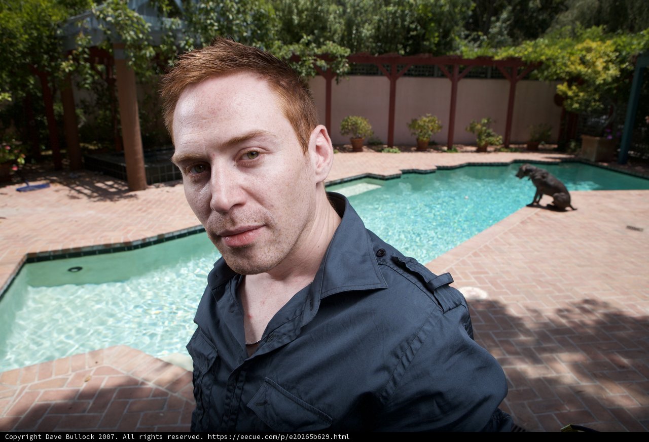 A Man and His Furry Friend by the Pool