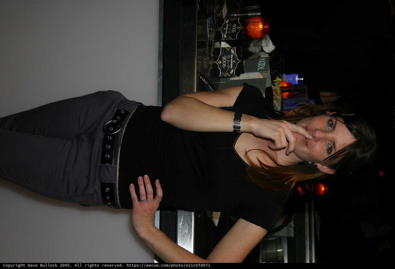 Woman Poses Thoughtfully at New Year's Eve Bar