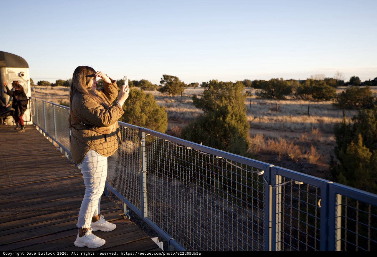 Woman Photographing Sunset at Desert Overlook