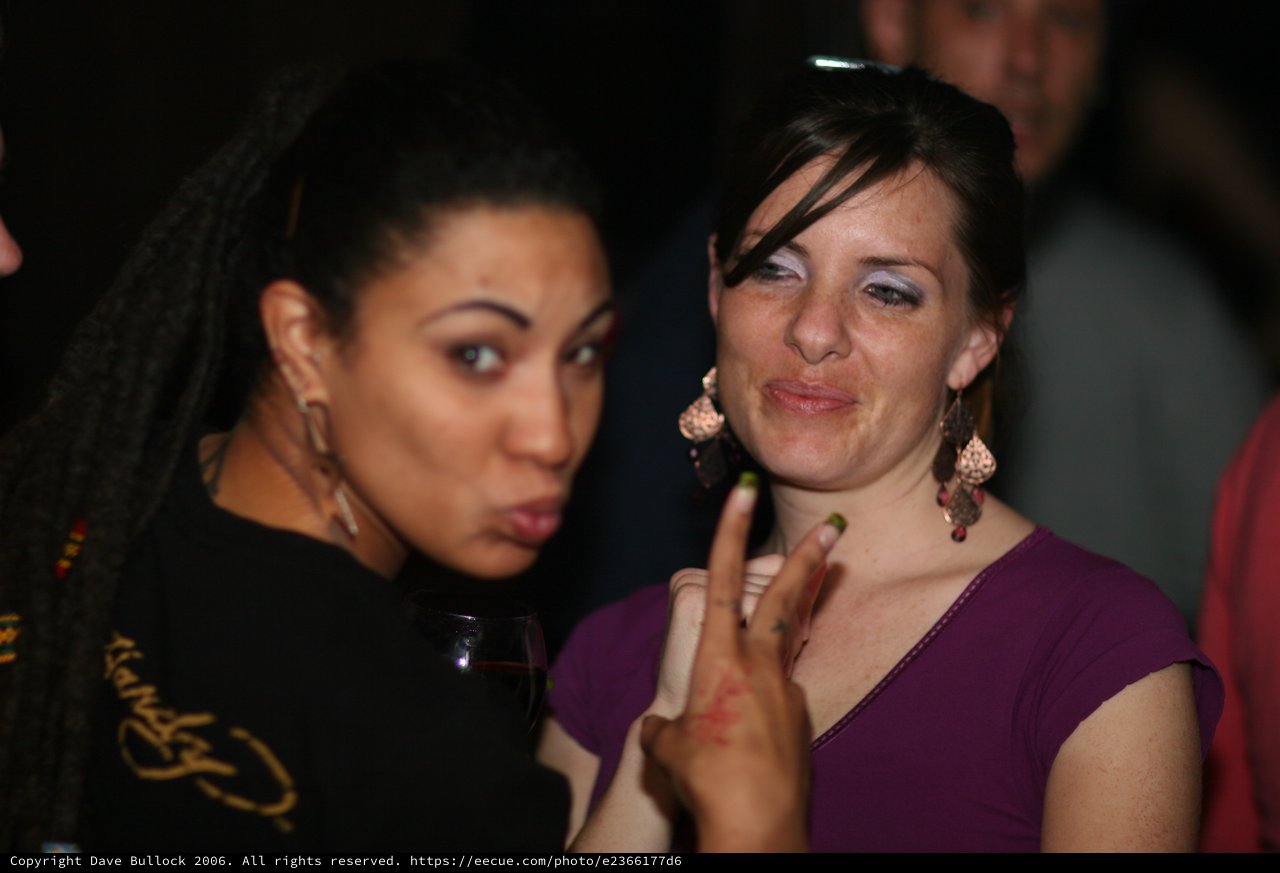 Two Friends Posing at a Nightclub Party